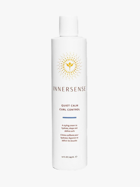 White bottle of Innersence Quiet Calm Curl Control with white cap on light gray background